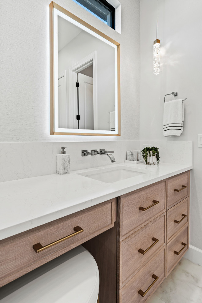 Inspiration for a transitional master gray tile and porcelain tile porcelain tile, white floor and double-sink walk-in shower remodel with shaker cabinets, light wood cabinets, a two-piece toilet, white walls, an undermount sink, quartz countertops, white countertops, a niche and a built-in vanity