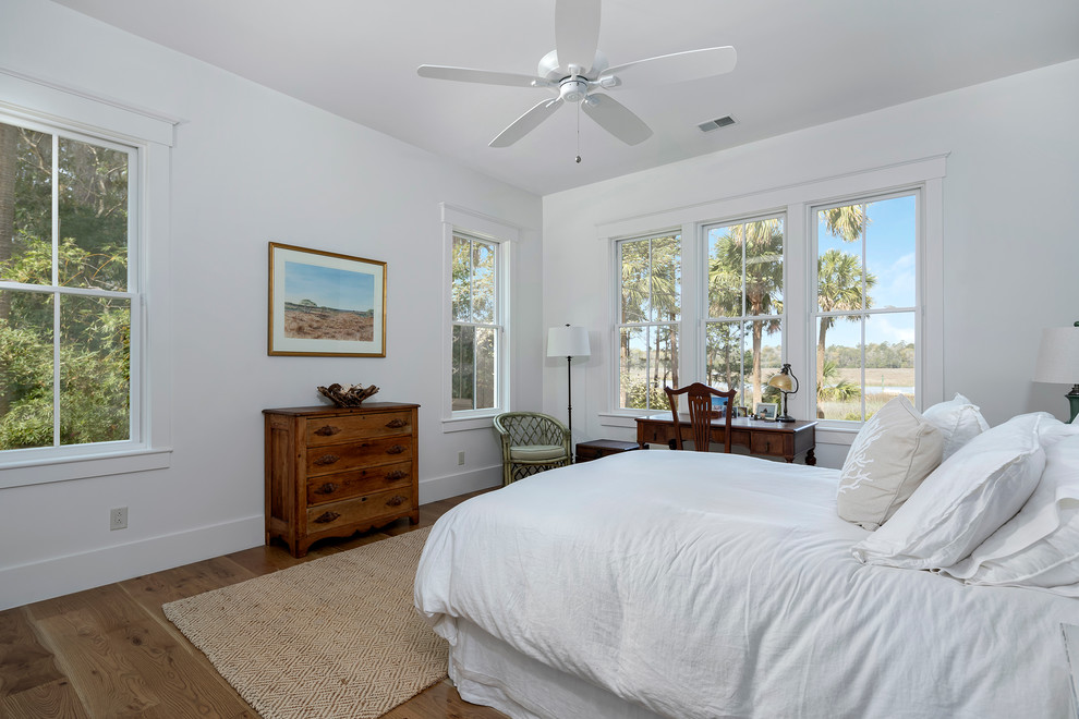 Mid-sized beach style master bedroom in Charleston with white walls, dark hardwood floors and brown floor.