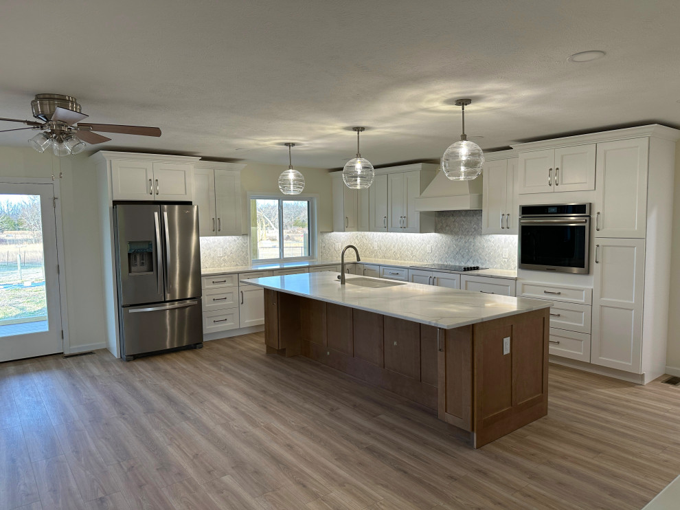 Large transitional kitchen photo with gray backsplash, marble backsplash and white countertops