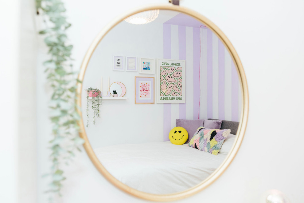Inspiration for a small contemporary kids' room for girls in London with purple walls.