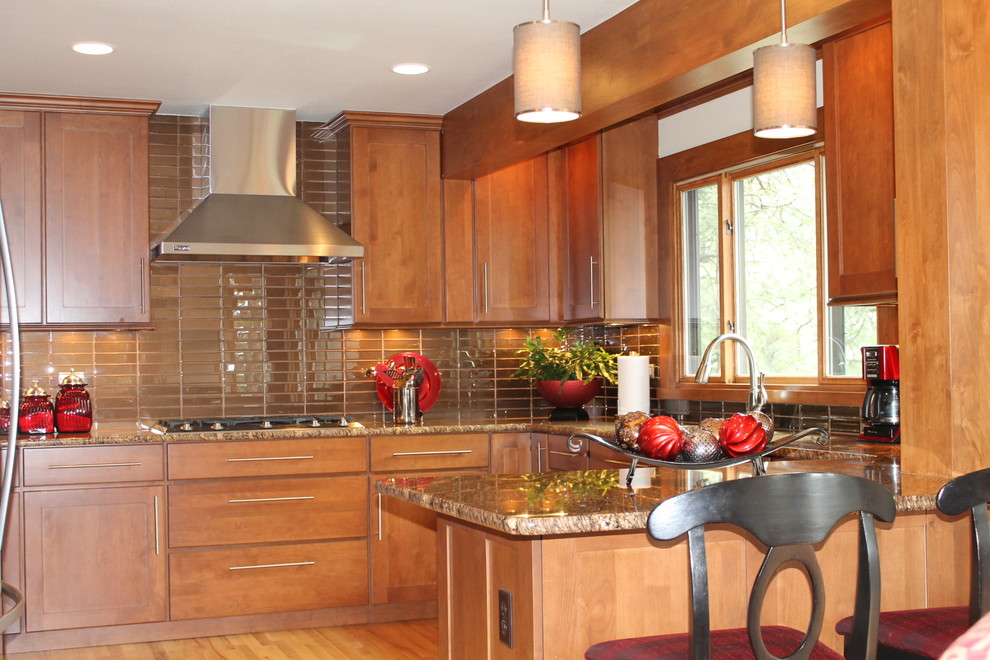 Large transitional u-shaped light wood floor eat-in kitchen photo in Denver with an undermount sink, flat-panel cabinets, dark wood cabinets, granite countertops, gray backsplash, glass tile backsplash, stainless steel appliances and a peninsula