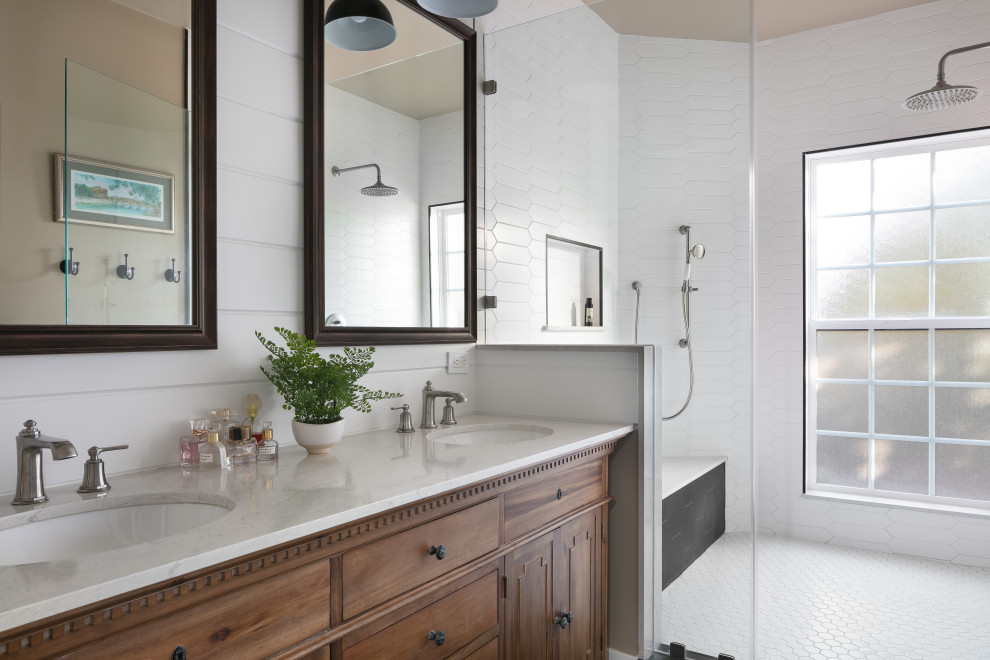 Inspiration for a large transitional master bathroom in Los Angeles with furniture-like cabinets, dark wood cabinets, a double shower, a one-piece toilet, white tile, subway tile, white walls, ceramic floors, an undermount sink, marble benchtops, black floor, beige benchtops, a shower seat, a double vanity, a freestanding vanity, planked wall panelling and a hinged shower door.