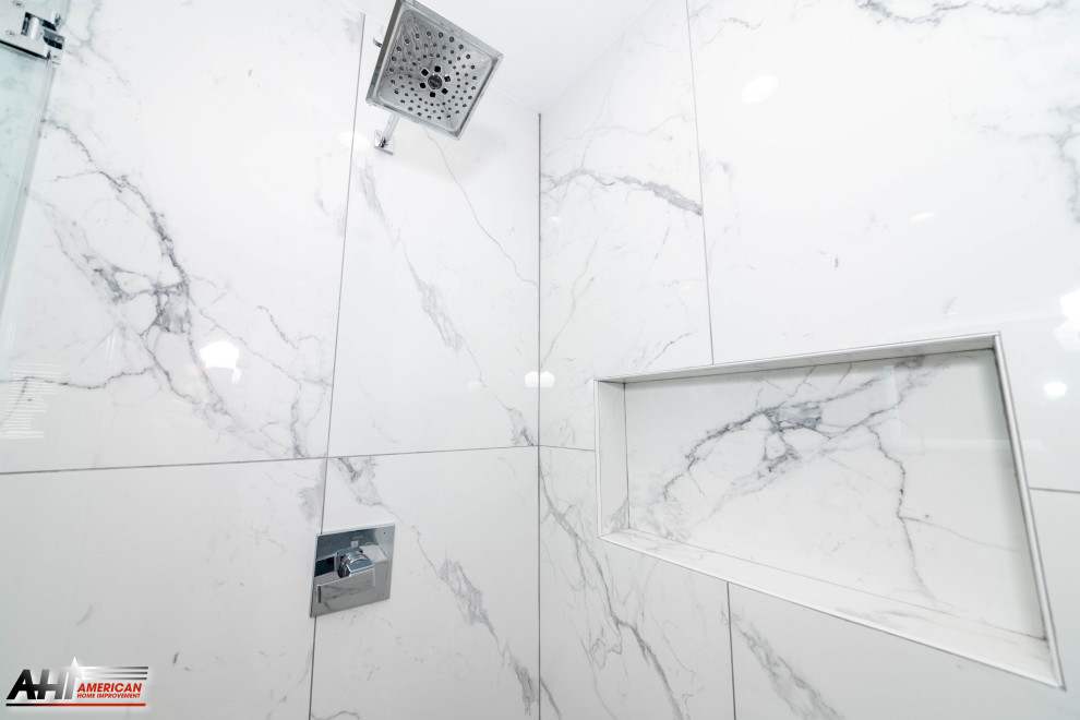 Photo of a mid-sized modern master bathroom in Los Angeles with raised-panel cabinets, white cabinets, a corner shower, a one-piece toilet, white tile, marble, grey walls, porcelain floors, a drop-in sink, marble benchtops, grey floor, a hinged shower door, white benchtops, a shower seat, a double vanity and a built-in vanity.