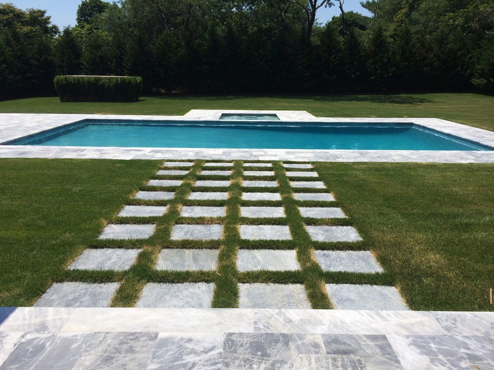 Hot tub - large backyard stone and rectangular lap hot tub idea in New York