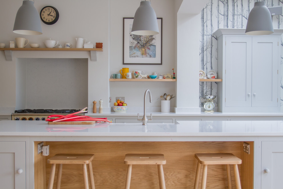 Inspiration for a large scandinavian l-shaped eat-in kitchen in Other with a farmhouse sink, shaker cabinets, white cabinets, quartz benchtops, coloured appliances and with island.