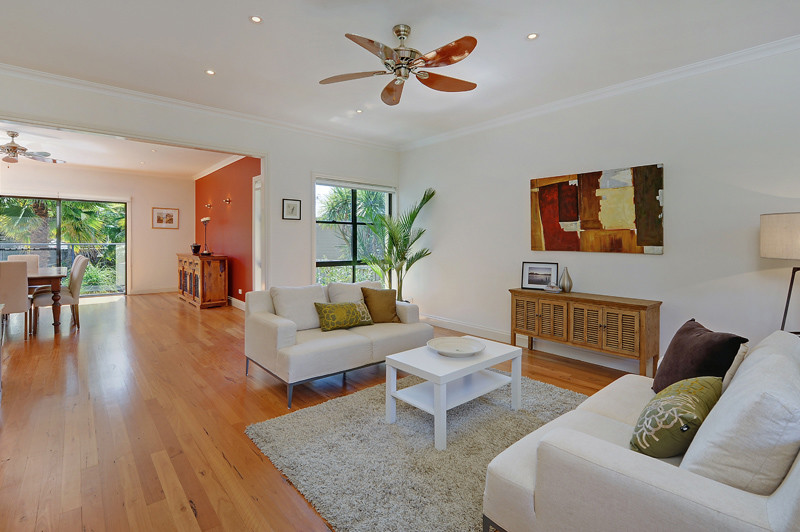 Photo of a large contemporary open concept living room in Sydney with white walls, light hardwood floors and brown floor.