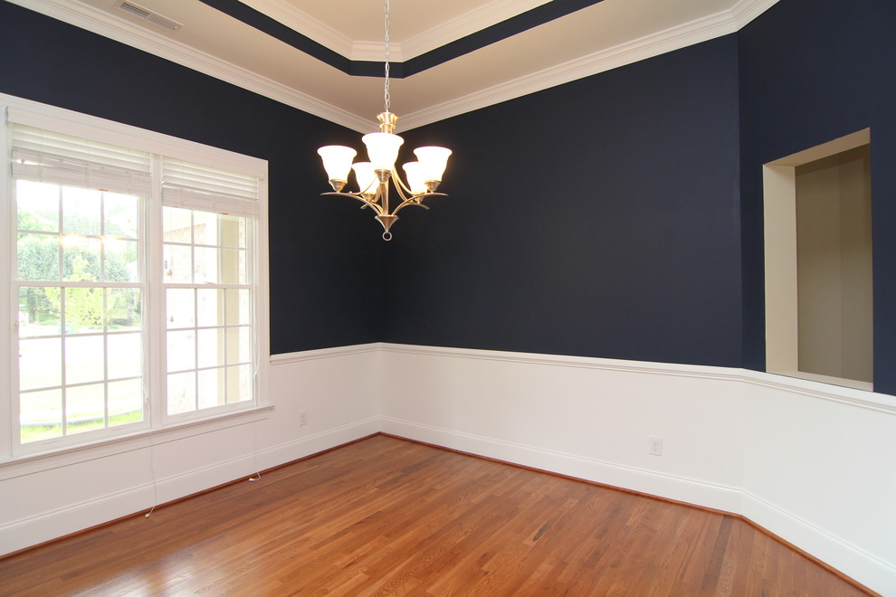 Large traditional separate dining room in Raleigh with blue walls and medium hardwood floors.