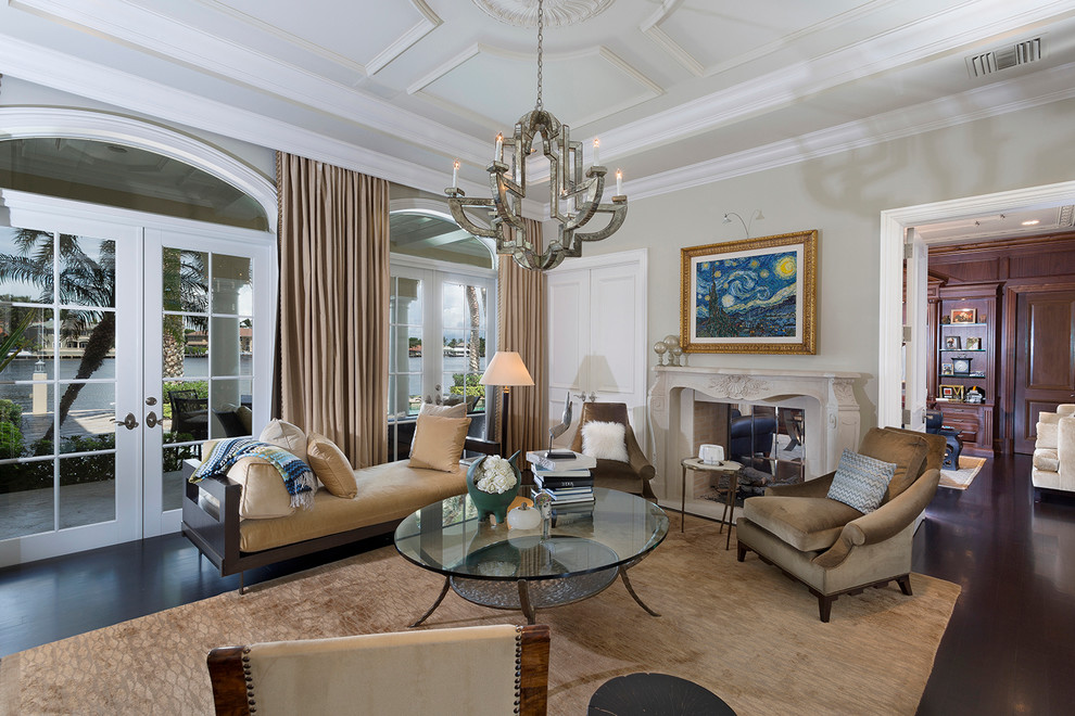 Traditional formal enclosed living room in Miami with grey walls, dark hardwood floors and a two-sided fireplace.
