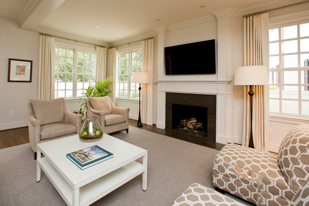 This is an example of a large traditional enclosed living room in Other with white walls, dark hardwood floors, a standard fireplace, a wood fireplace surround and a wall-mounted tv.