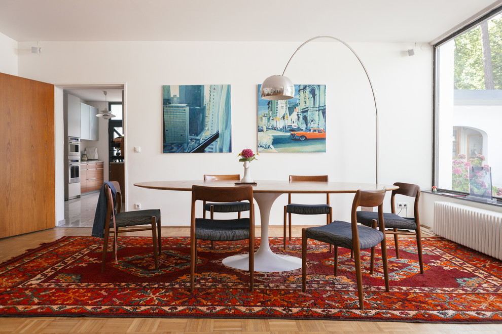 Mid-sized midcentury separate dining room in Berlin with white walls and medium hardwood floors.
