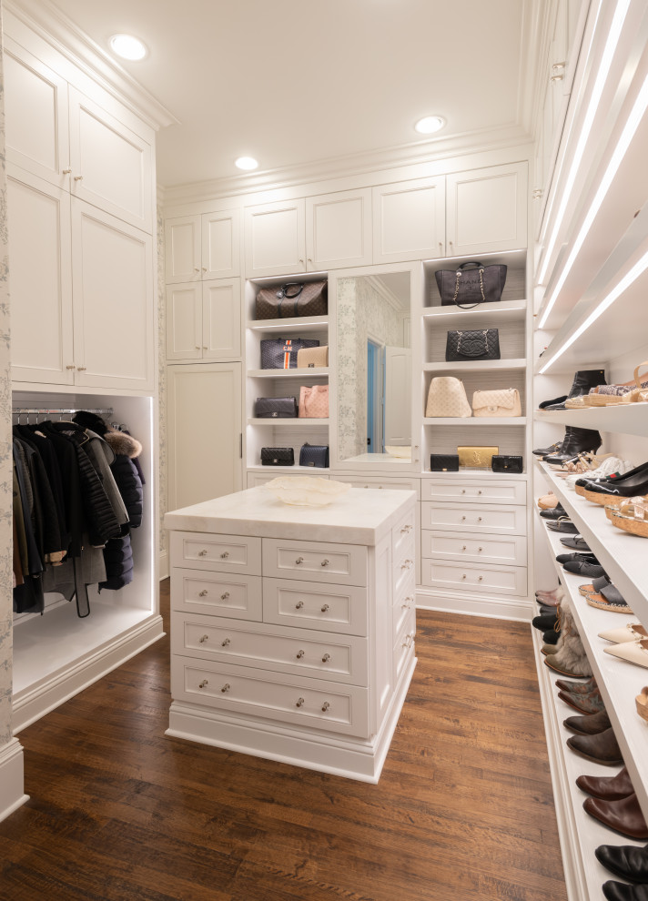 Design ideas for a large transitional women's walk-in wardrobe in Dallas with recessed-panel cabinets, white cabinets, medium hardwood floors and brown floor.