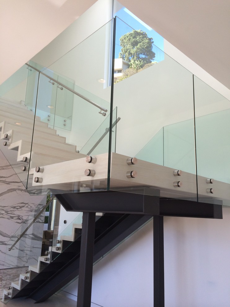 Staircase - mid-sized contemporary wooden floating glass railing staircase idea in Los Angeles with wooden risers