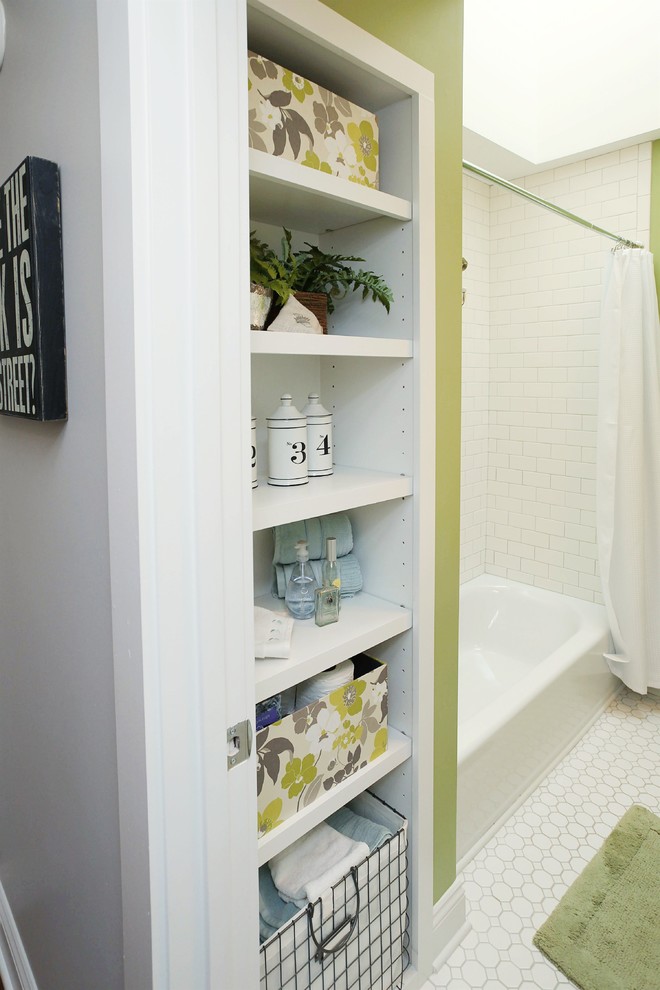 This is an example of a mid-sized modern bathroom in Charlotte with a shower/bathtub combo, white tile, subway tile and green walls.