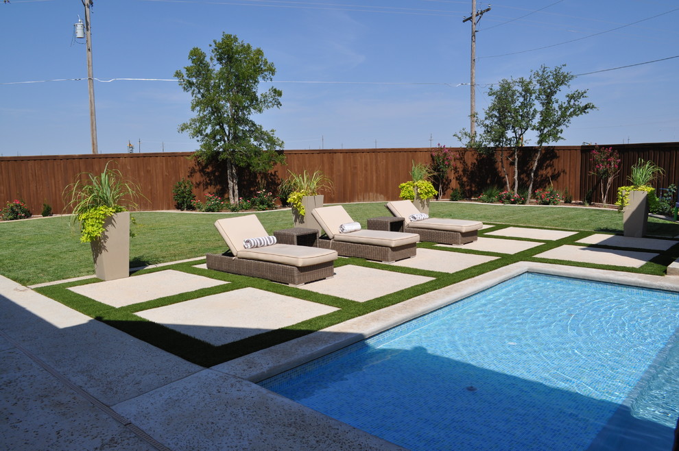 Example of a large transitional backyard concrete paver and rectangular lap pool house design in Austin