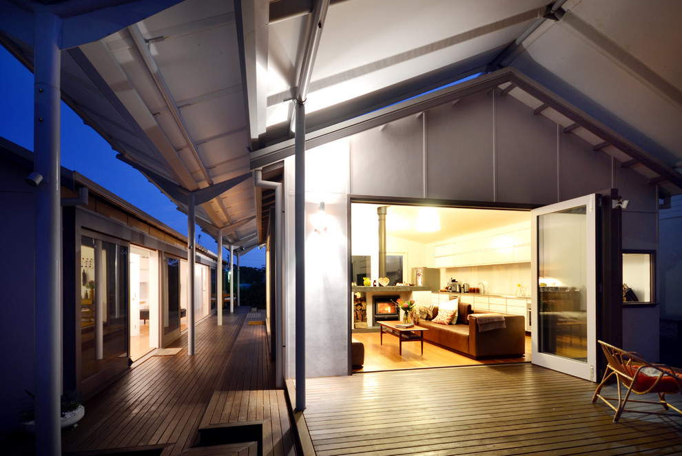 This is an example of a beach style deck in Sydney with an awning.