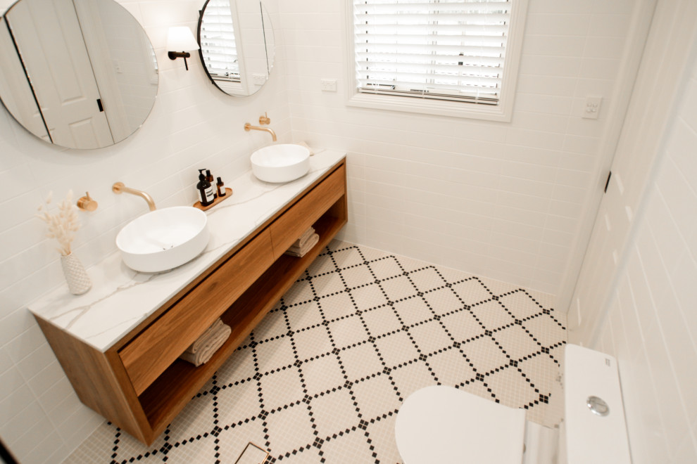 Design ideas for a mid-sized contemporary master bathroom in Sydney with medium wood cabinets, a freestanding tub, an open shower, white tile, a vessel sink, an open shower, a niche, a double vanity and a floating vanity.