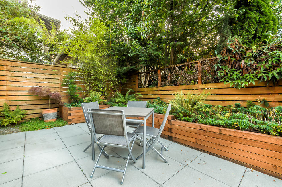 Design ideas for a mid-sized contemporary backyard patio in Seattle with concrete pavers and no cover.