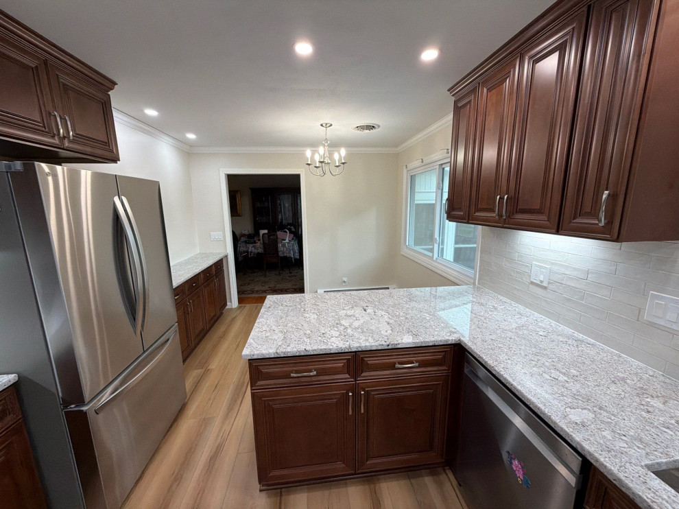USCD cabinetry accompanied granite countertops, porcelain tile backsplash and Ca