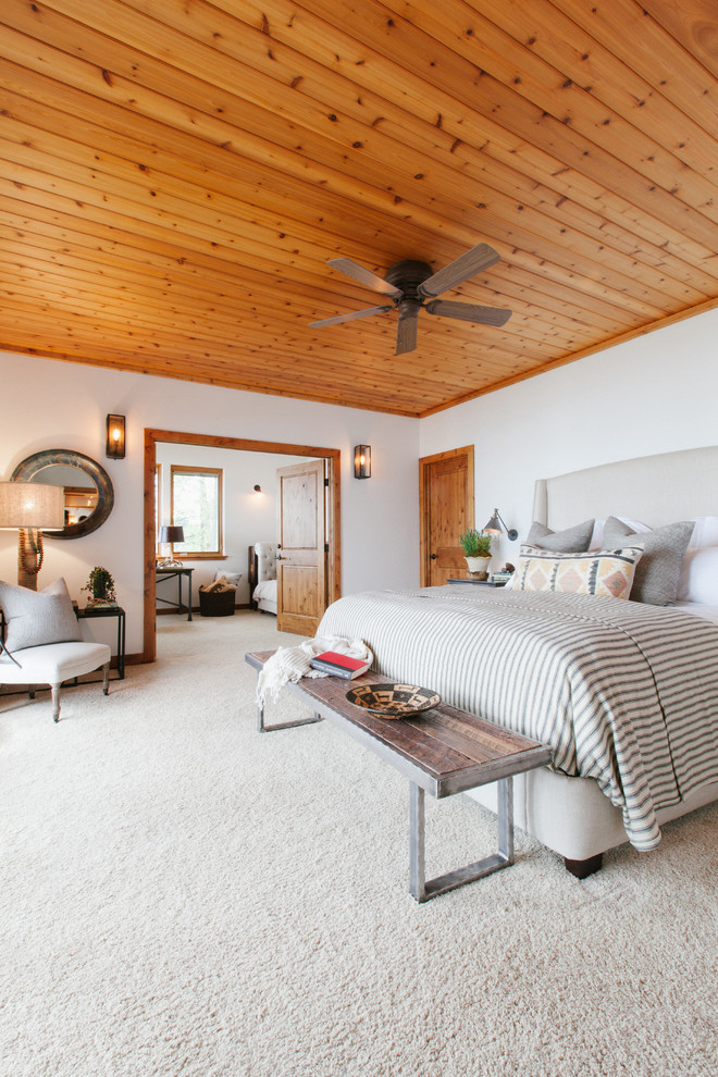 Inspiration for a country master bedroom in Orange County with white walls and carpet.