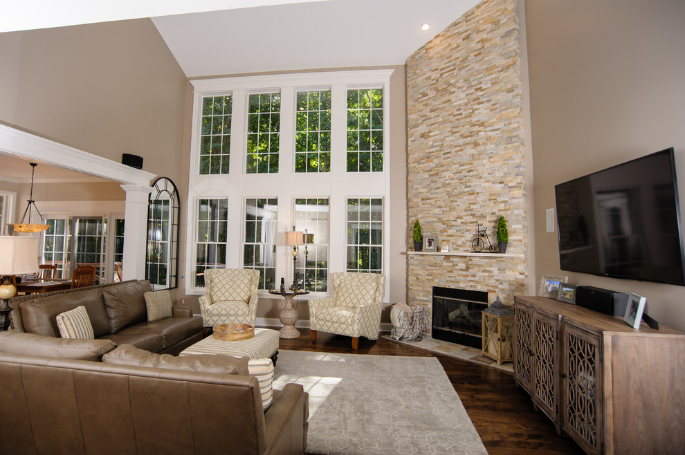 Inspiration for a mid-sized transitional open concept living room in Detroit with brown walls, medium hardwood floors, a corner fireplace, a stone fireplace surround and a wall-mounted tv.