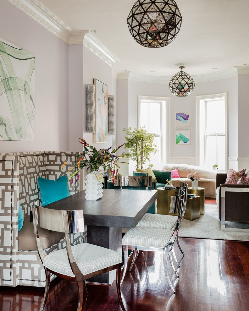 This is an example of a mid-sized contemporary open plan dining in Boston with purple walls, medium hardwood floors, a standard fireplace and a plaster fireplace surround.