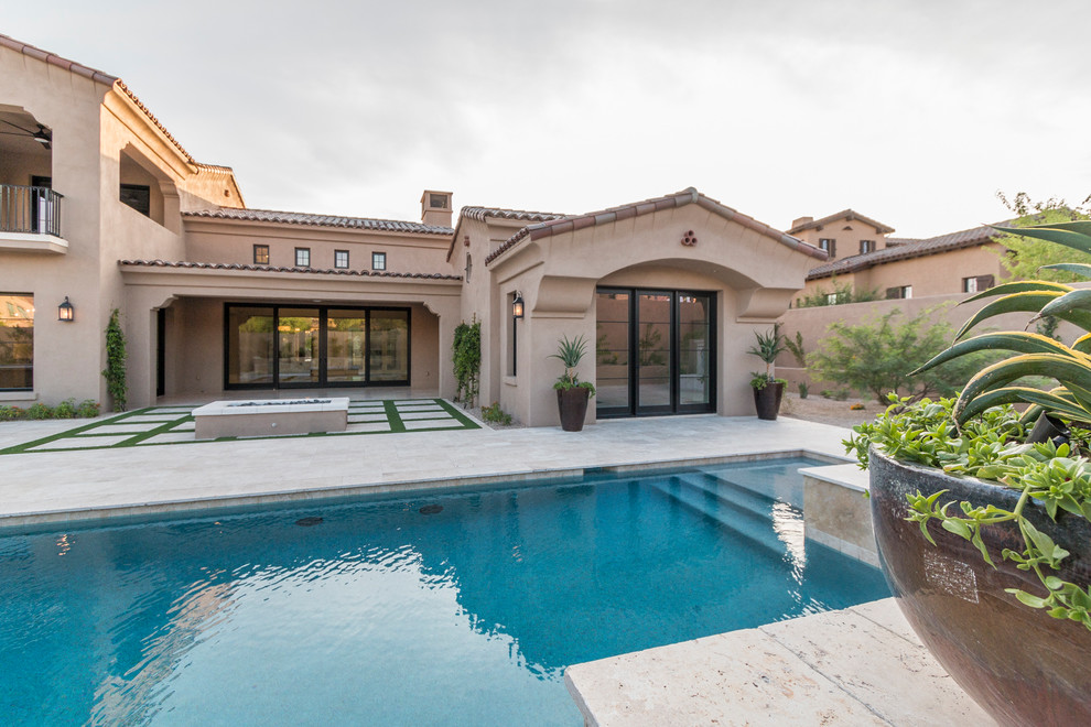 Inspiration for a huge transitional beige two-story stucco house exterior remodel in Phoenix with a tile roof