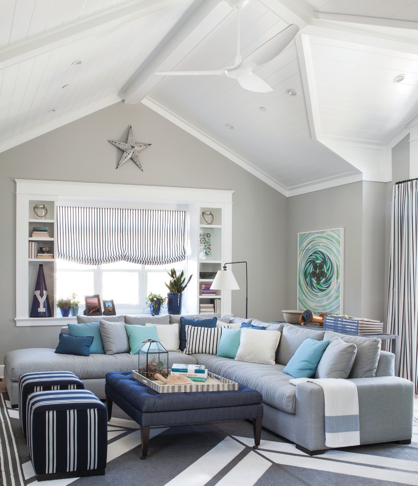 Photo of a large beach style family room in Other with grey walls.