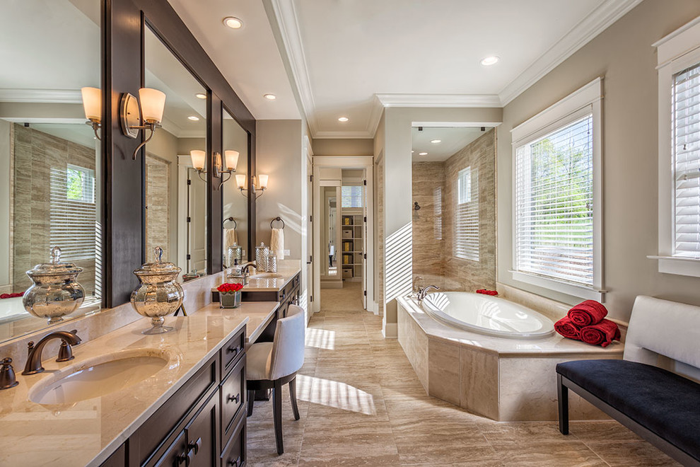 Inspiration for a large traditional master bathroom in Other with dark wood cabinets, a drop-in tub, travertine floors, an undermount sink, marble benchtops, shaker cabinets, an open shower, beige tile, porcelain tile, beige walls, brown floor and a hinged shower door.