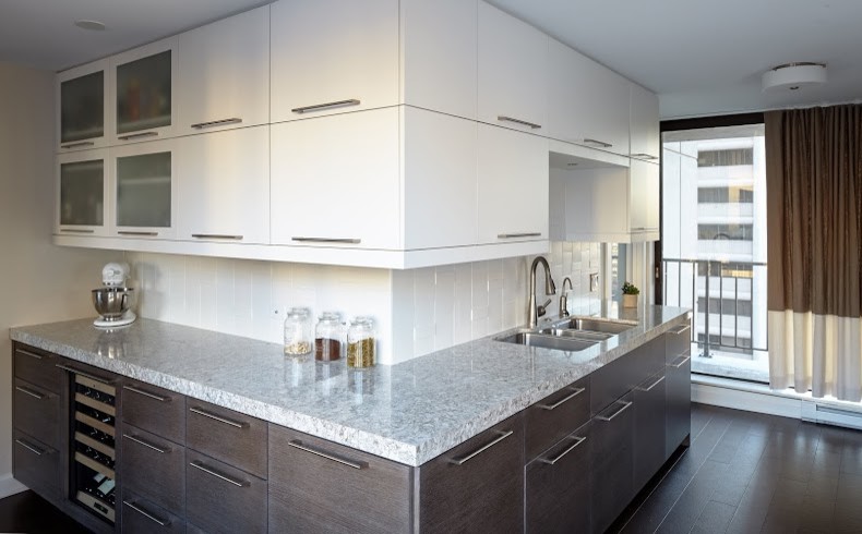 Photo of a mid-sized contemporary galley eat-in kitchen in Chicago with a triple-bowl sink, flat-panel cabinets, dark wood cabinets, granite benchtops, white splashback, porcelain splashback, dark hardwood floors, no island and brown floor.
