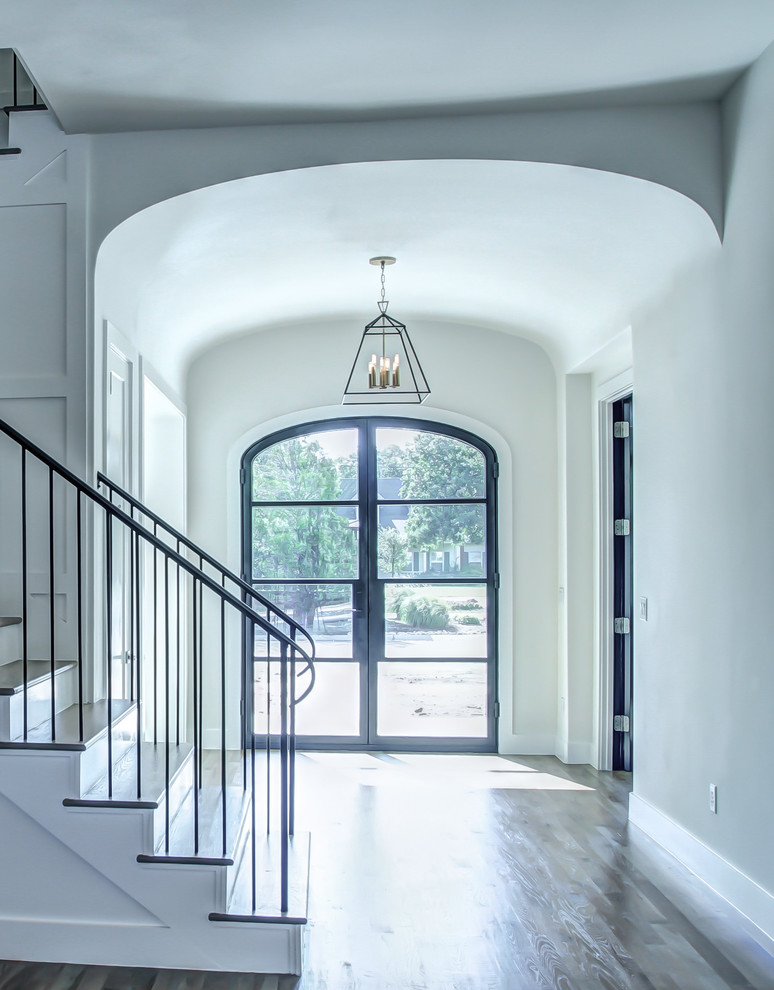 This is an example of a mid-sized entry hall in Dallas with white walls, dark hardwood floors, a single front door and a black front door.