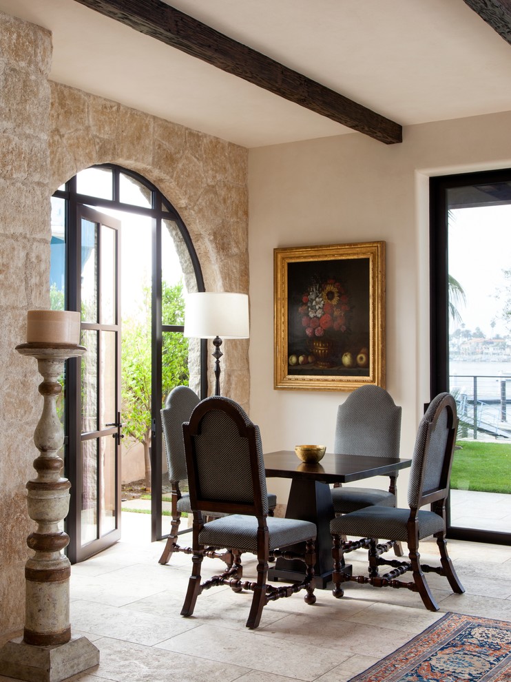 Inspiration for a mediterranean dining room in Orange County with limestone floors.
