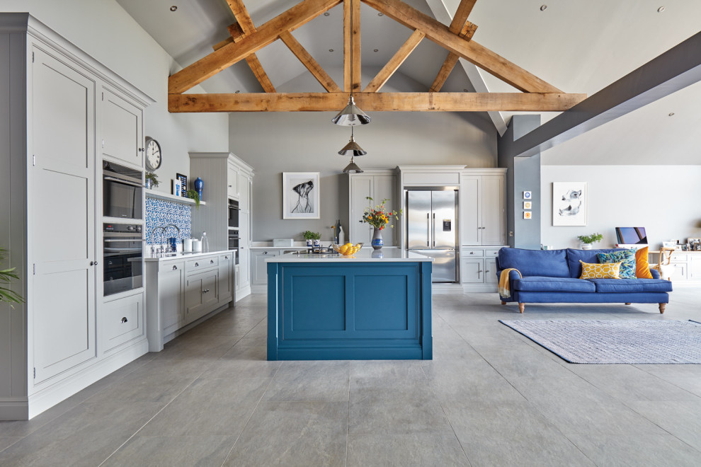 This is an example of a large contemporary l-shaped open plan kitchen with an integrated sink, shaker cabinets, grey cabinets, quartz worktops, blue splashback, stone tiled splashback, stainless steel appliances, porcelain flooring, an island, grey floors and white worktops.
