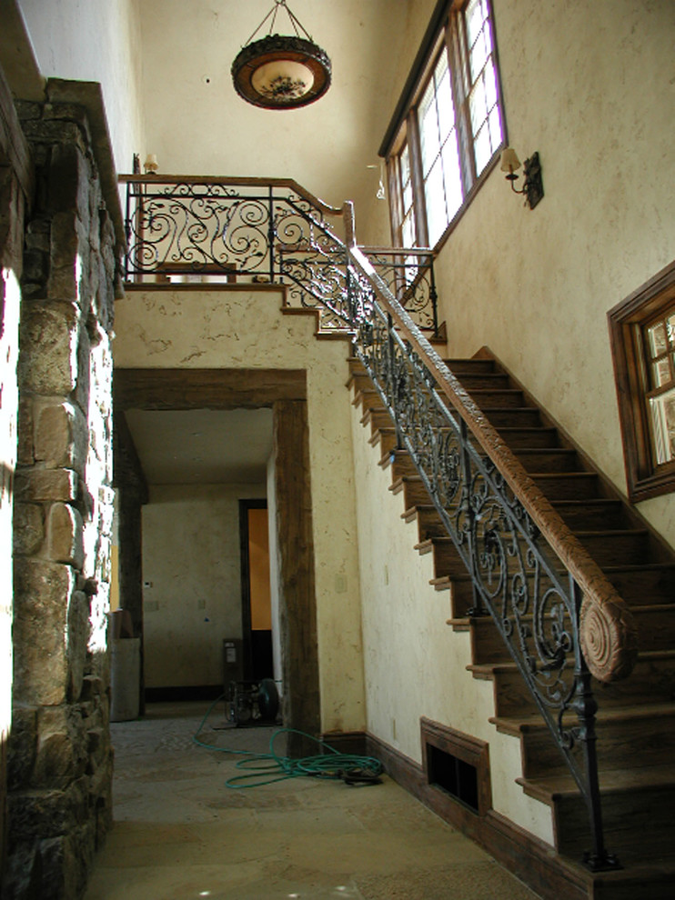 This is an example of a large arts and crafts wood l-shaped staircase in Other with wood risers and mixed railing.