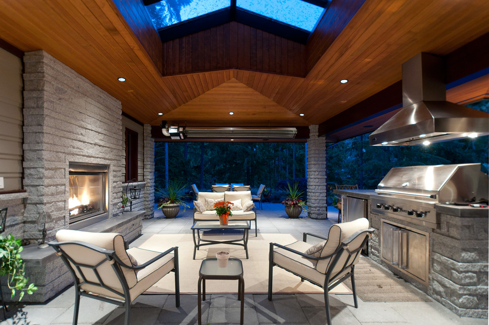 Photo of a contemporary patio in Vancouver with a roof extension.