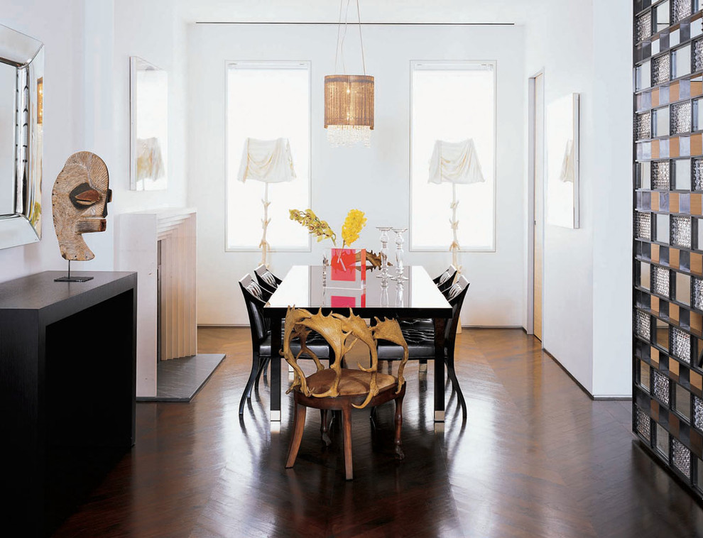 Contemporary dining room in New York with white walls and dark hardwood floors.