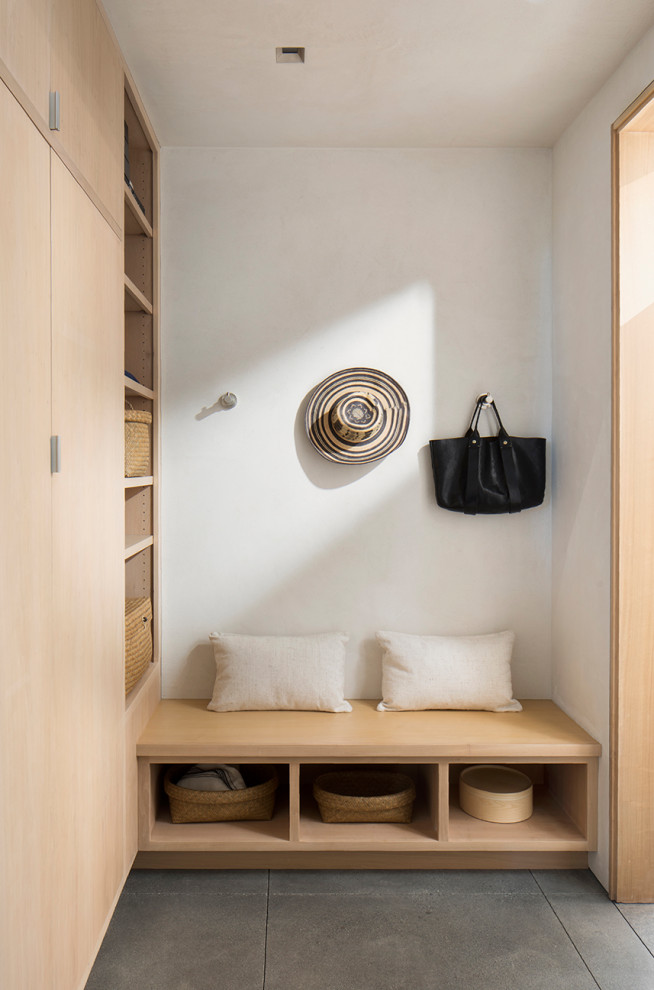 This is an example of an expansive contemporary mudroom in San Francisco with beige walls.