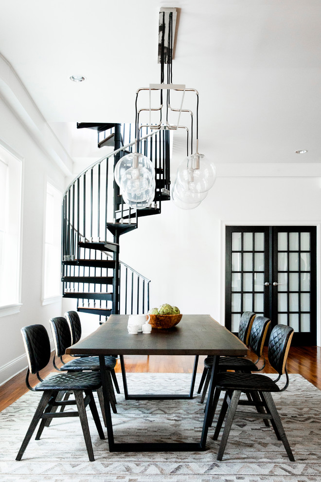 Photo of a contemporary dining room in Philadelphia with white walls, dark hardwood floors and brown floor.