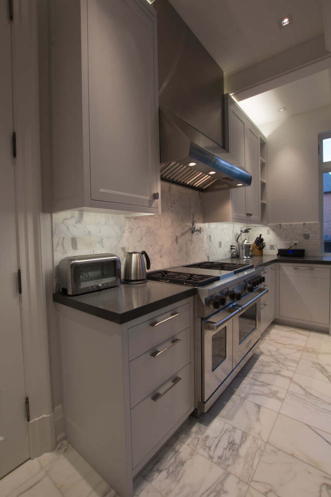 Inspiration for a large transitional l-shaped marble floor, gray floor and coffered ceiling enclosed kitchen remodel in Toronto with an integrated sink, flat-panel cabinets, stainless steel cabinets, quartz countertops, white backsplash, marble backsplash, stainless steel appliances, two islands and gray countertops