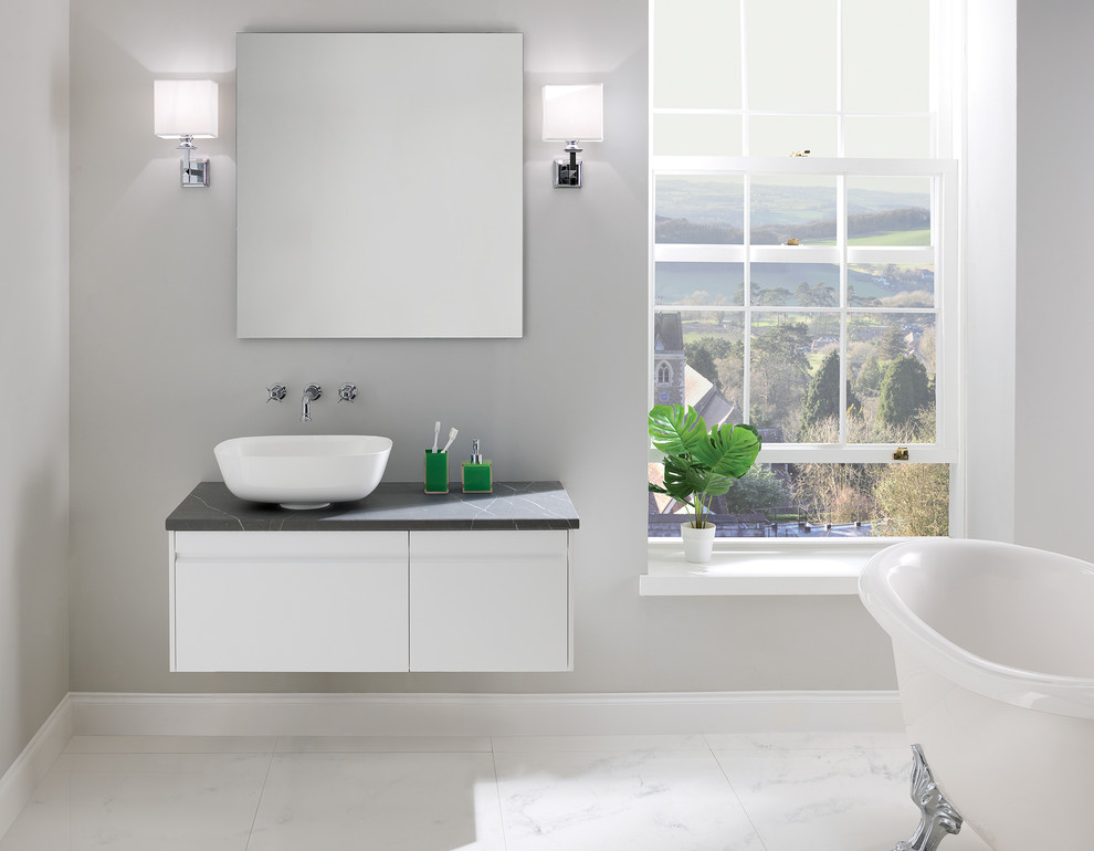 This is an example of a small contemporary master bathroom in West Midlands with white cabinets, a claw-foot tub, marble floors, a vessel sink, laminate benchtops, white floor and grey benchtops.