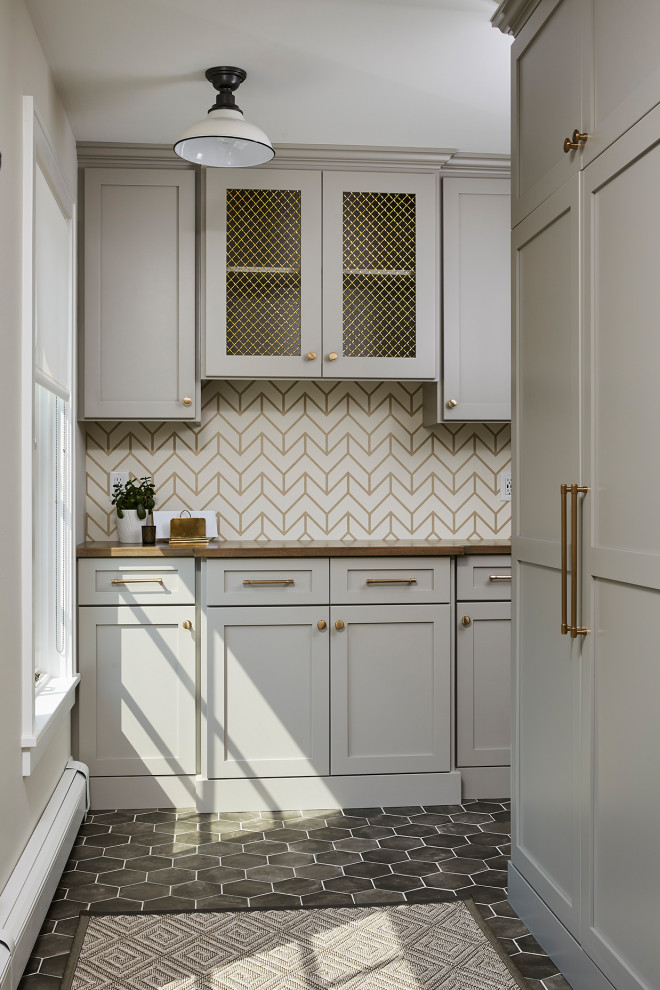 This is an example of a mid-sized transitional mudroom in Minneapolis with beige walls, porcelain floors and grey floor.