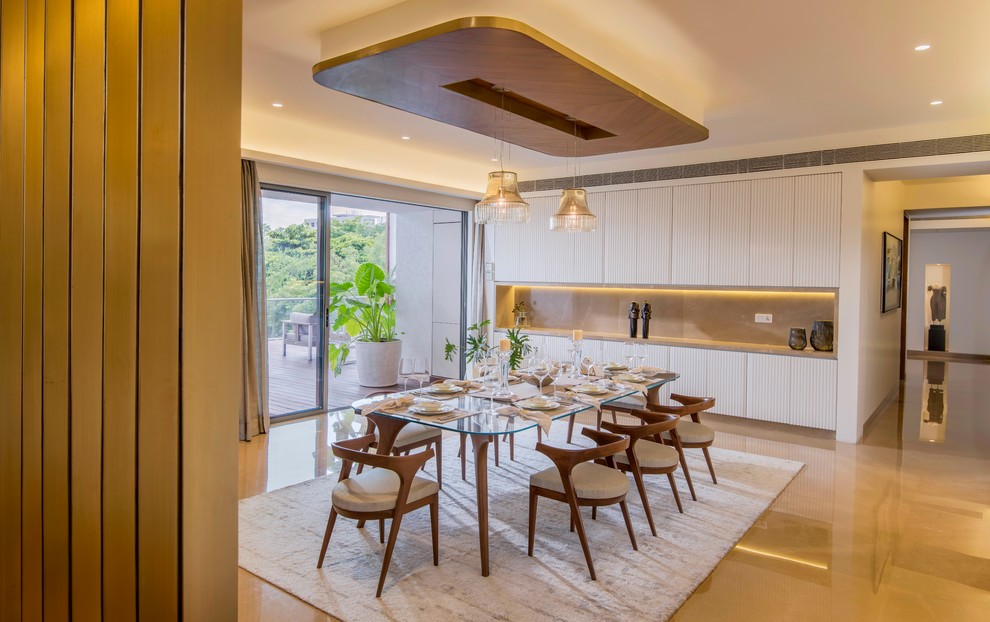 Design ideas for an asian open plan dining in Pune with white walls and brown floor.