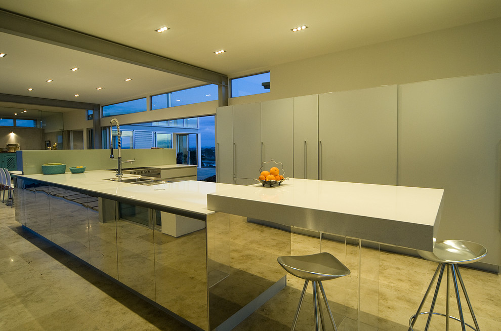 Inspiration for a contemporary u-shaped eat-in kitchen in Auckland with flat-panel cabinets and white cabinets.