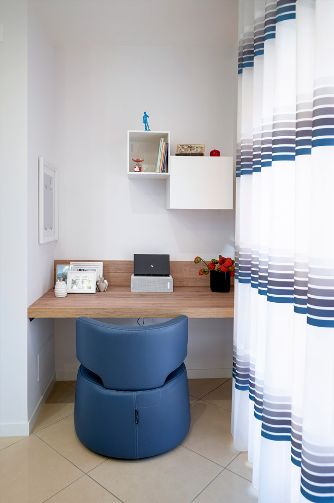 This is an example of a medium sized contemporary home office with white walls, porcelain flooring and beige floors.