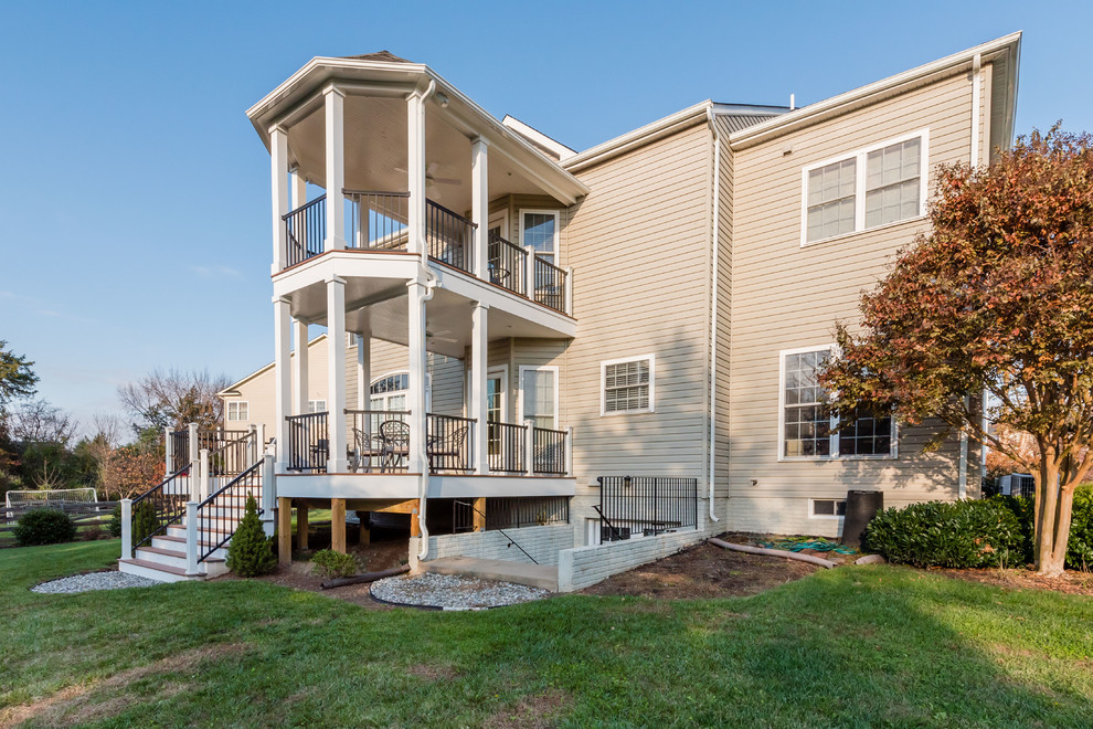 Large transitional backyard deck photo with decking and a roof extension