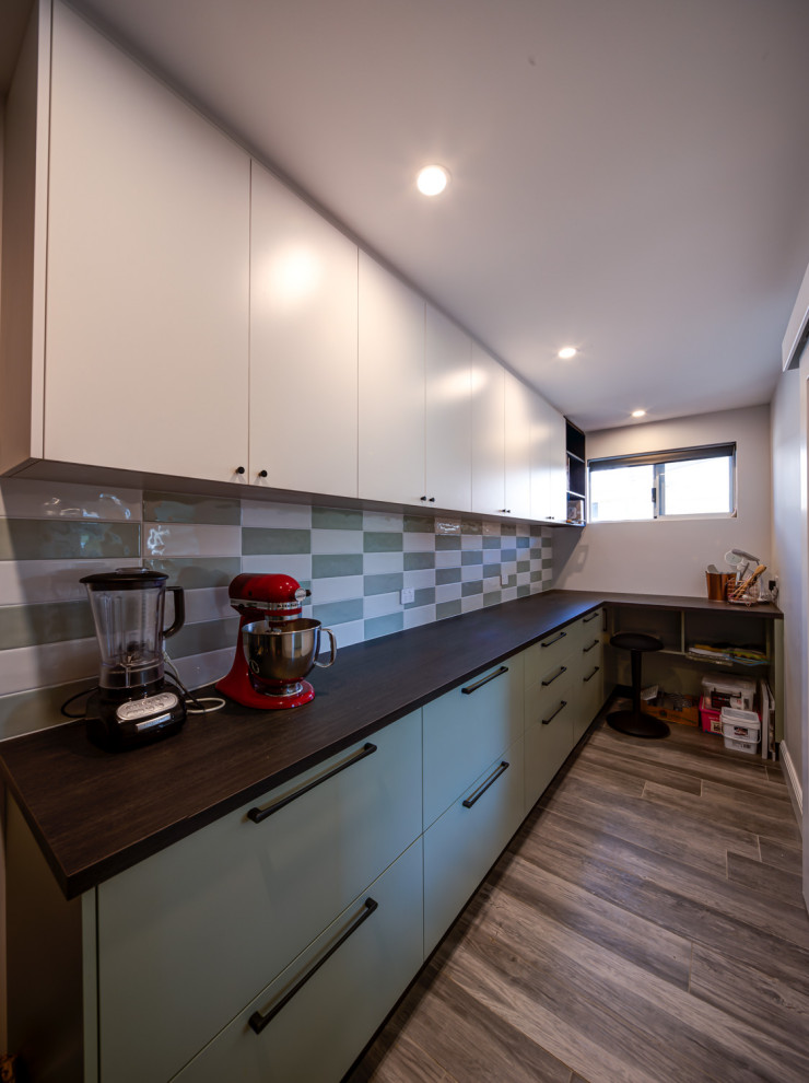 This is an example of an eclectic galley kitchen in Perth with white benchtop.