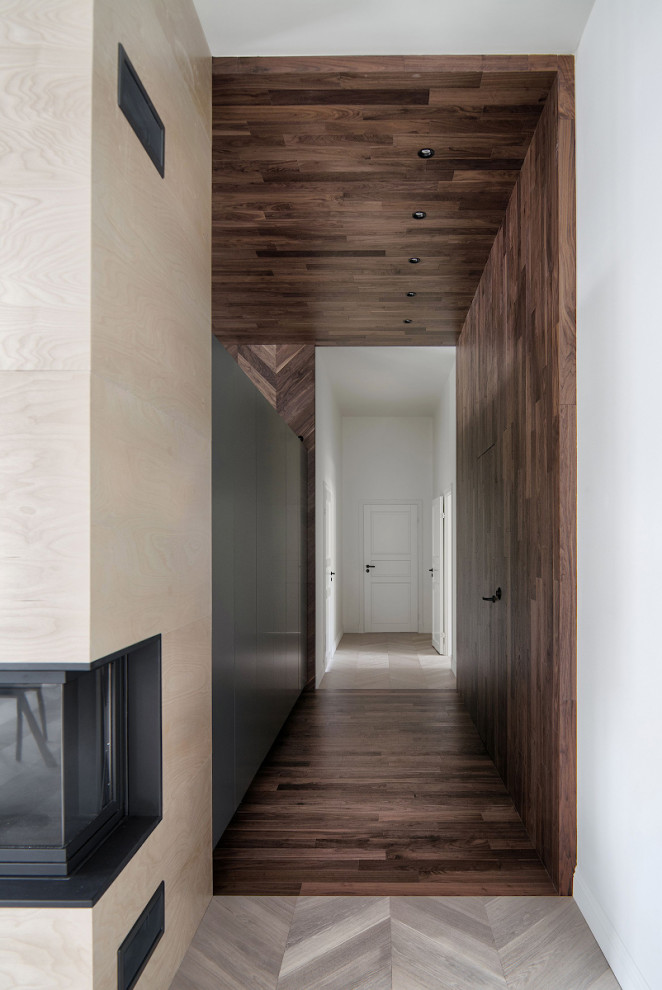 Design ideas for a scandinavian hallway in Saint Petersburg with grey walls and light hardwood floors.