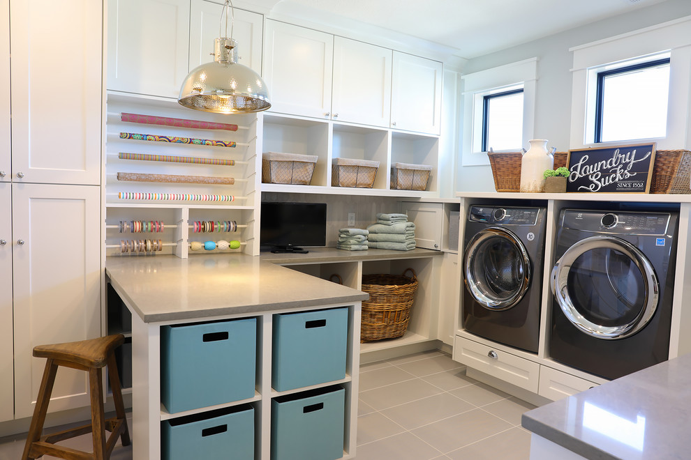 Mid-sized country dedicated laundry room in Portland with an undermount sink, shaker cabinets, white cabinets, quartz benchtops, grey walls, porcelain floors, a side-by-side washer and dryer, grey floor and grey benchtop.