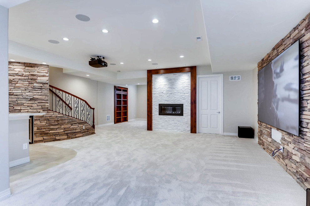 Design ideas for an expansive country fully buried basement in Denver with white walls, carpet, a standard fireplace, a stone fireplace surround and white floor.