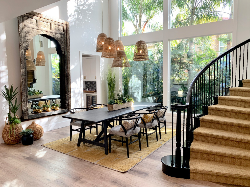 Inspiration for a large tropical dining room with white walls, vinyl floors and beige floor.