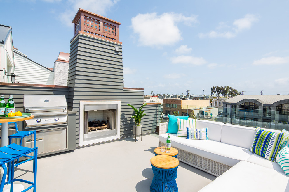 This is an example of a mid-sized beach style rooftop and rooftop deck in Orange County with with fireplace and no cover.